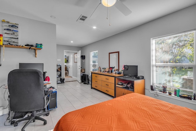 tiled bedroom featuring ceiling fan and multiple windows