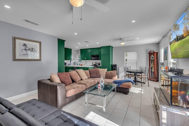 tiled living room featuring ceiling fan