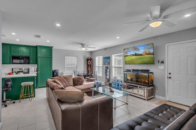 living room with light tile patterned flooring and ceiling fan