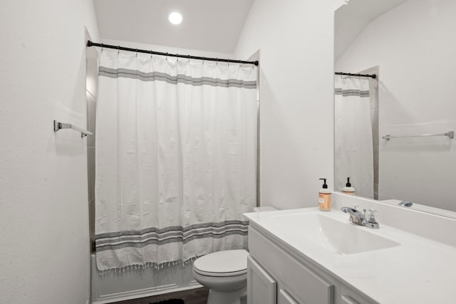 full bathroom featuring toilet, vanity, lofted ceiling, and shower / bathtub combination with curtain