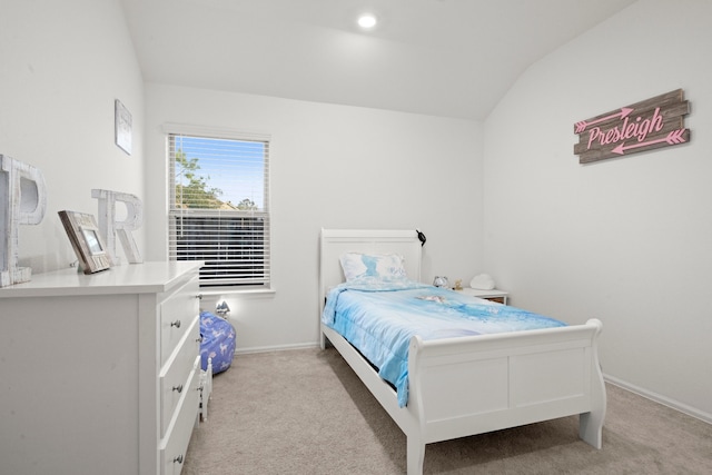 bedroom with light colored carpet and lofted ceiling