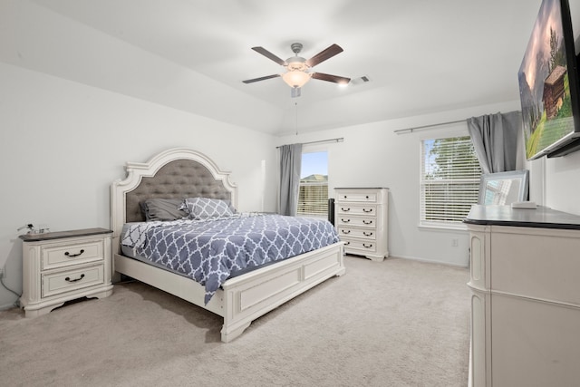 carpeted bedroom featuring multiple windows and ceiling fan