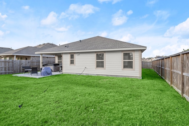 back of house featuring a patio and a yard