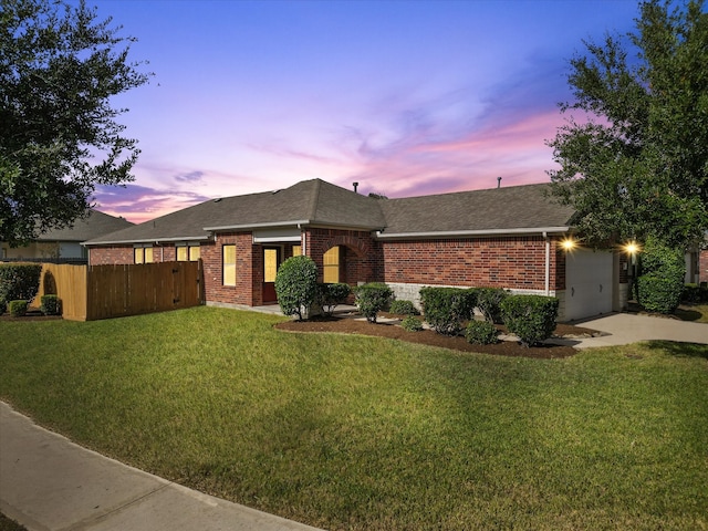 view of front of property featuring a yard and a garage