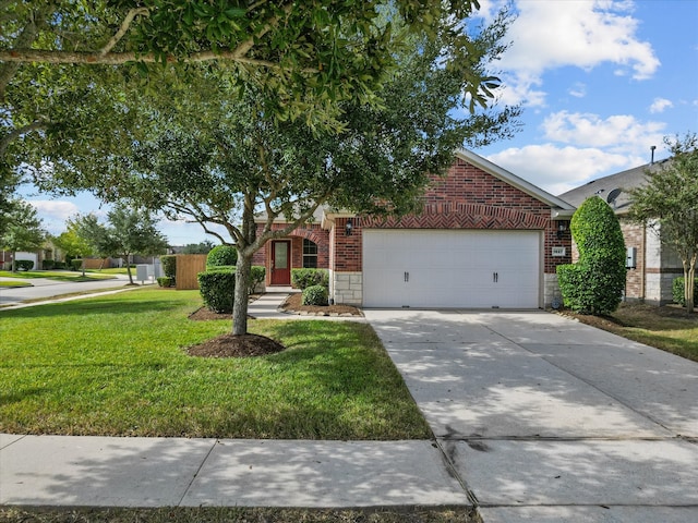 view of property hidden behind natural elements featuring a front lawn and a garage