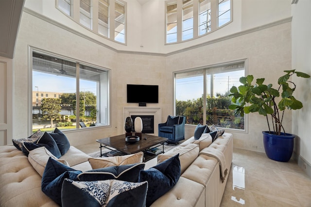 living room featuring a towering ceiling and plenty of natural light