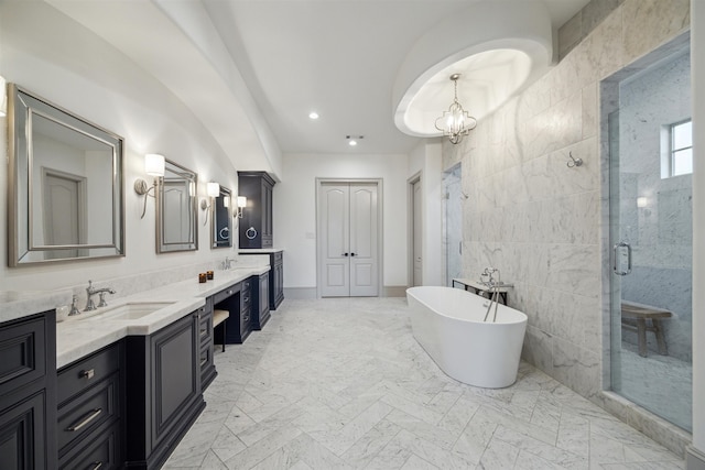 bathroom with tile walls, vanity, and separate shower and tub