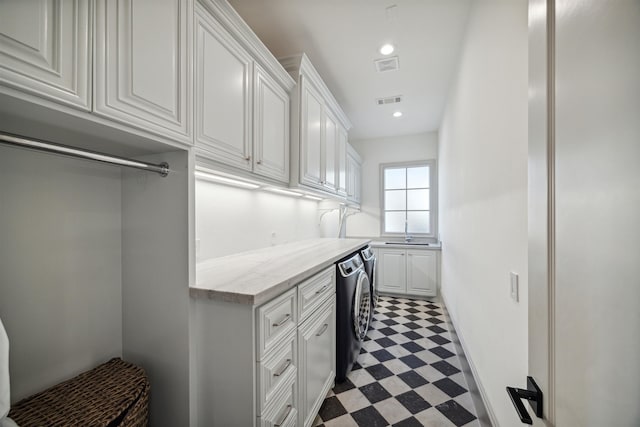 interior space featuring cabinets, washer / dryer, and sink