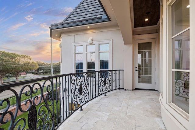 view of balcony at dusk