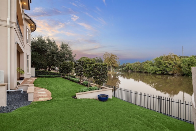 yard at dusk with a water view