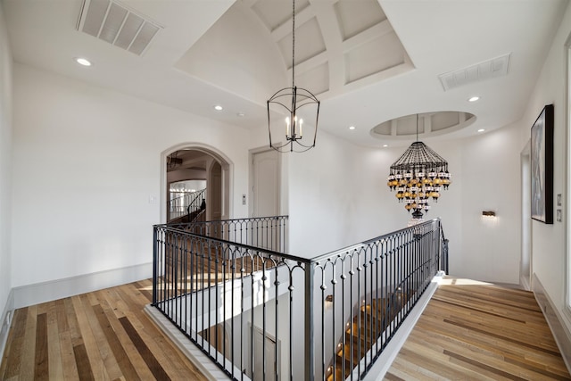 hall featuring hardwood / wood-style floors and a towering ceiling