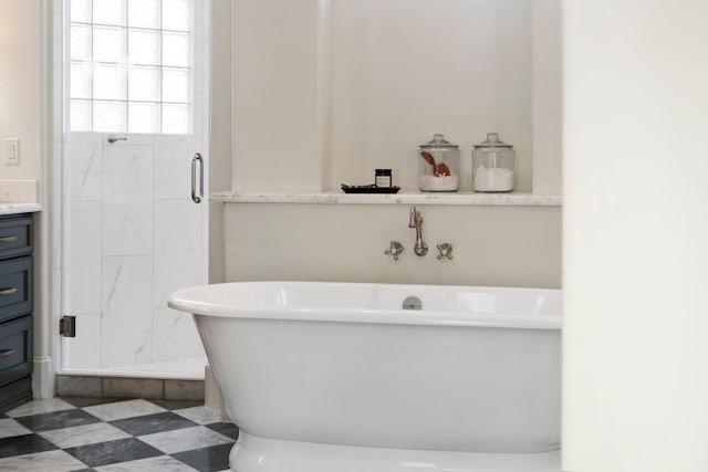 bathroom featuring vanity and shower with separate bathtub