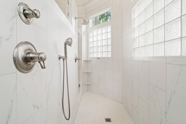 bathroom with a tile shower