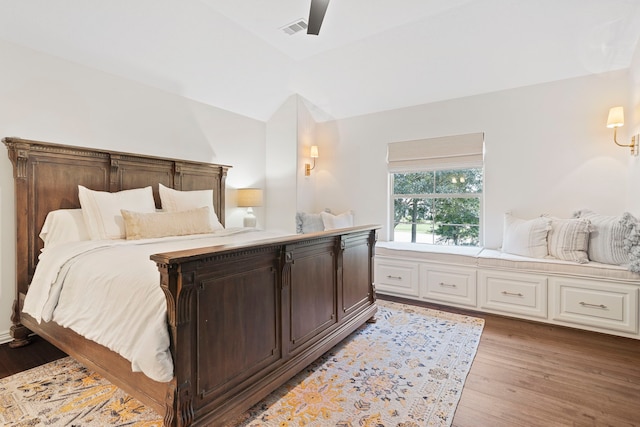 bedroom with vaulted ceiling, light hardwood / wood-style flooring, and ceiling fan