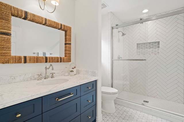 bathroom featuring vanity, tile patterned flooring, toilet, and walk in shower