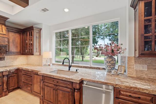 kitchen featuring tasteful backsplash, sink, and a wealth of natural light