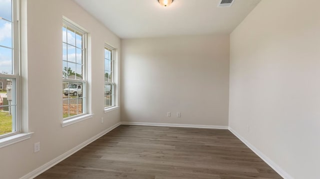 spare room with dark hardwood / wood-style floors