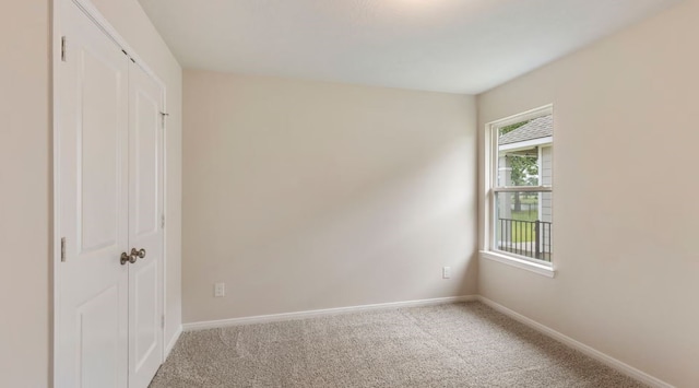 unfurnished bedroom with light carpet and a closet