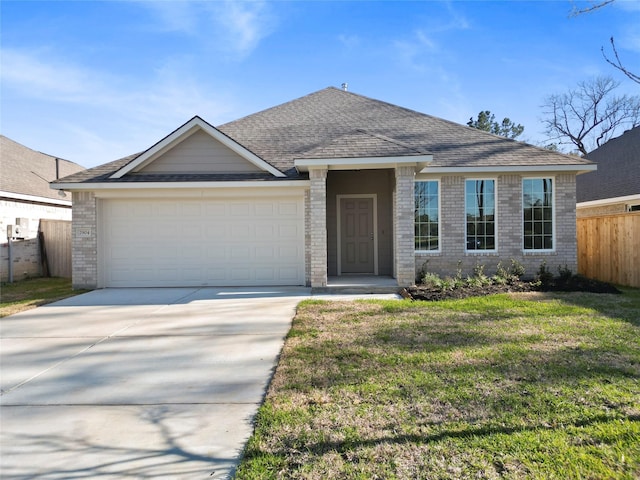 view of front of property featuring a garage, a front lawn, driveway, and fence