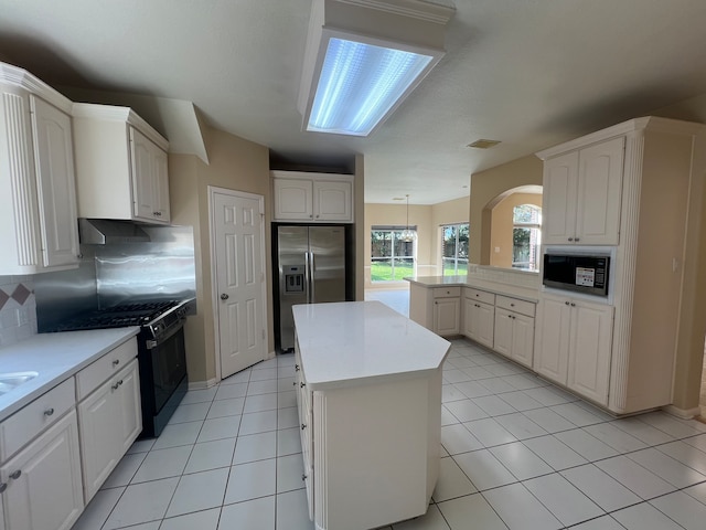 kitchen with a kitchen island, white cabinets, and black appliances