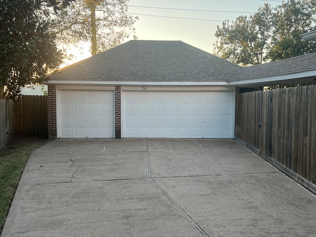 view of garage at dusk