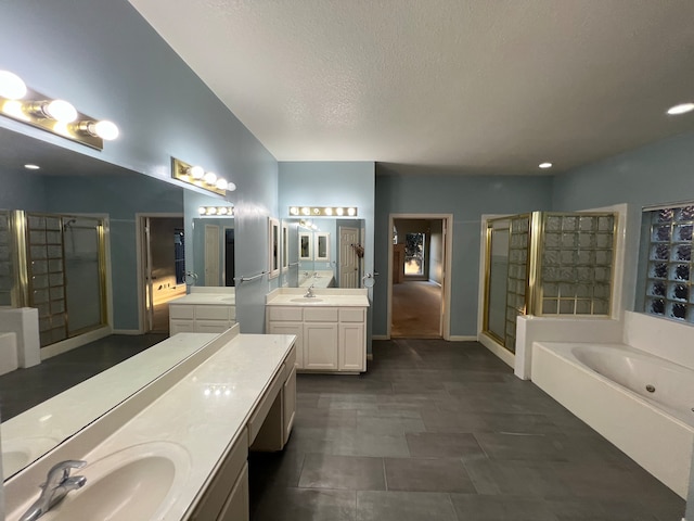 bathroom featuring vanity, plus walk in shower, and a textured ceiling