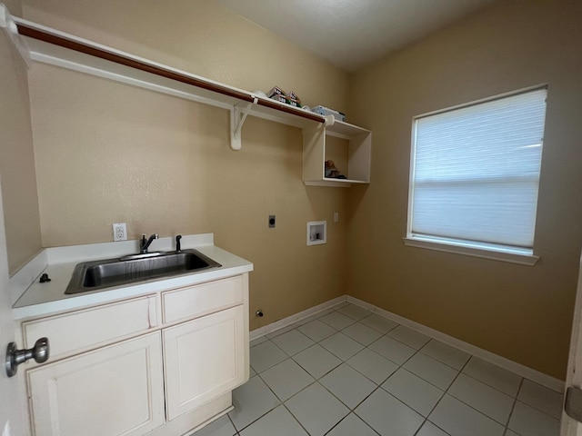 clothes washing area featuring sink, light tile patterned floors, electric dryer hookup, hookup for a washing machine, and cabinets