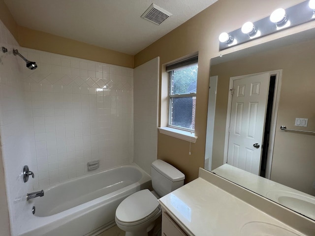 full bathroom featuring vanity, toilet, and tiled shower / bath