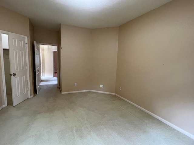 empty room with light colored carpet