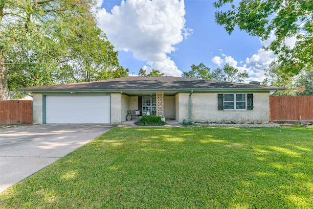 ranch-style home with a front lawn and a garage