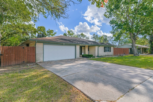 ranch-style house featuring a front yard and a garage