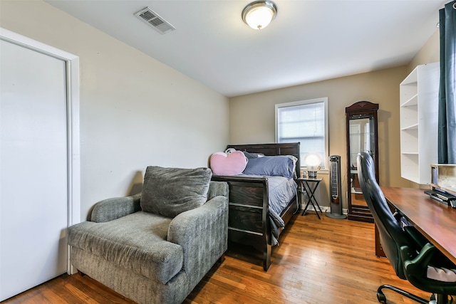 bedroom with dark hardwood / wood-style floors