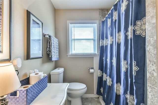 bathroom featuring toilet and walk in shower