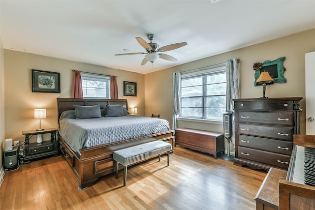 bedroom with light hardwood / wood-style floors and ceiling fan