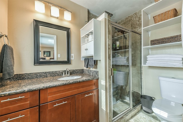 bathroom featuring toilet, walk in shower, and vanity