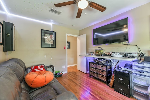 living room featuring ceiling fan and hardwood / wood-style floors