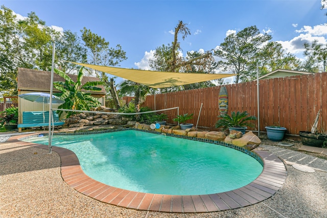 view of swimming pool featuring a shed