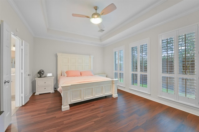 bedroom featuring dark hardwood / wood-style floors, a raised ceiling, ceiling fan, and crown molding