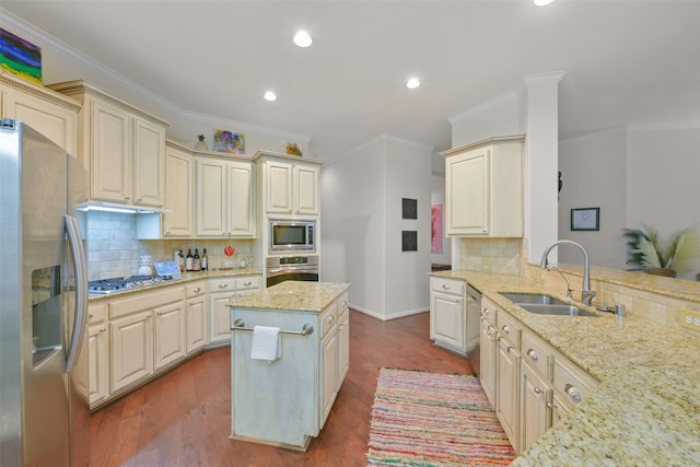 kitchen featuring light stone counters, sink, hardwood / wood-style flooring, and appliances with stainless steel finishes