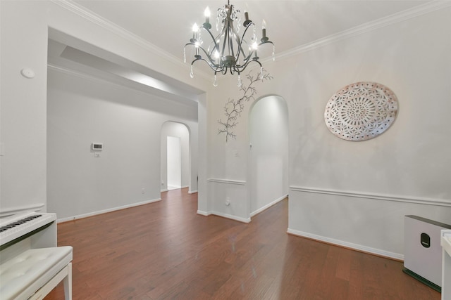 unfurnished dining area featuring dark wood-type flooring, a notable chandelier, and ornamental molding