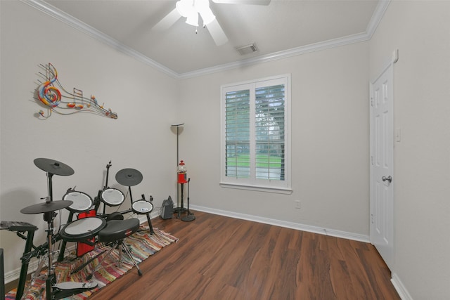 rec room with ceiling fan, dark hardwood / wood-style floors, and ornamental molding