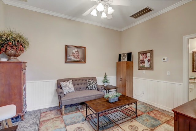 living room with ceiling fan and ornamental molding