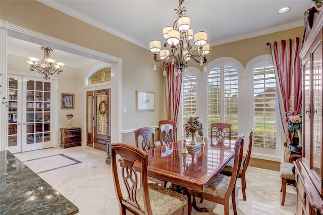 dining room with a chandelier, french doors, and ornamental molding