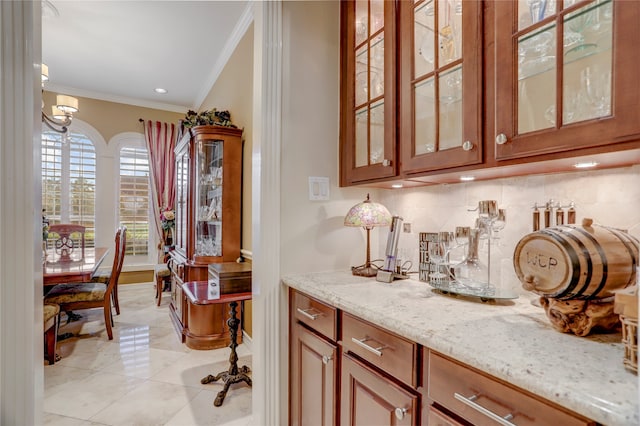 bar featuring light stone countertops, light tile patterned floors, decorative backsplash, and ornamental molding