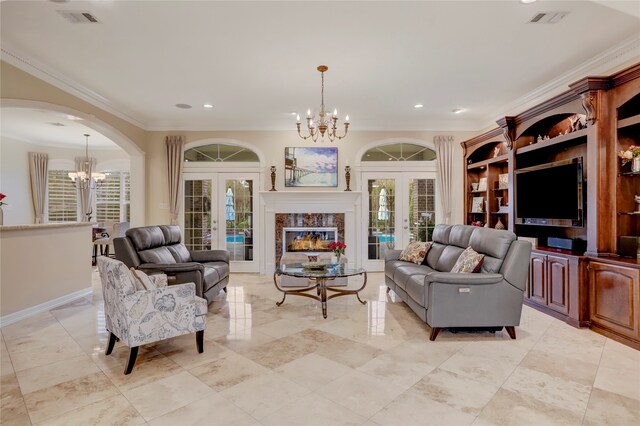 living room with ornamental molding, french doors, plenty of natural light, and a premium fireplace