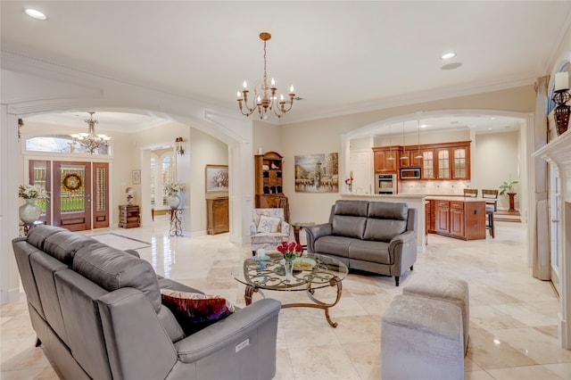 living room featuring a notable chandelier and ornamental molding