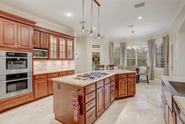 kitchen featuring appliances with stainless steel finishes, ornamental molding, hanging light fixtures, a chandelier, and decorative backsplash