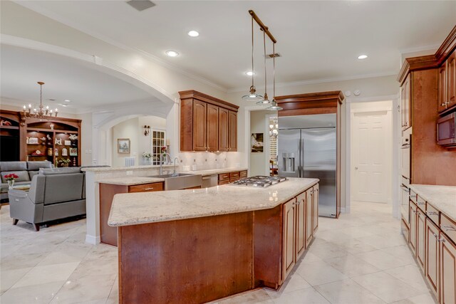 kitchen featuring a kitchen island, decorative light fixtures, and stainless steel appliances