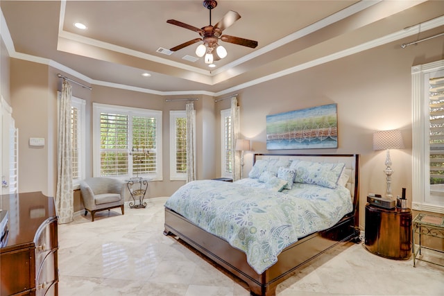 bedroom featuring a tray ceiling, ceiling fan, and crown molding