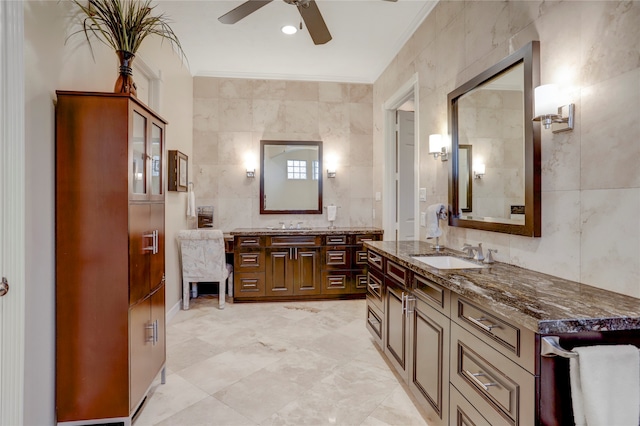 bathroom with tile walls, vanity, ceiling fan, and crown molding